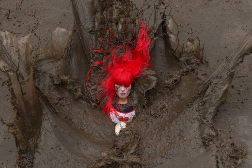 A competitor falls in a muddy pool as they take part in the Tough Guy endurance event near Wolverhampton, central England, on January 27, 2019.