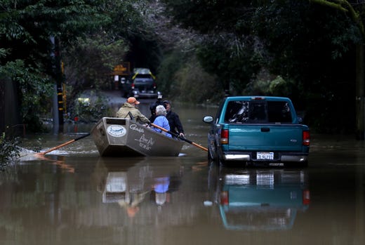 Residents use a boat to navigate floodwaters on Feb. 15, 2019 in Guerneville, Calif. An atmospheric river, a narrow corridor of concentrated moisture in the atmosphere, is bringing heavy rains to Northern California that is causing rivers to overflow their banks and flood many areas around the Russian River. 