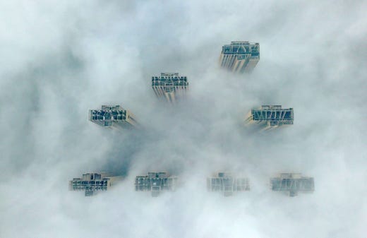 TOPSHOT - This aerial view shows the tops of highrise buildings poking out from heavy fog in Yangzhou, in China's eastern Jiangsu province on January 14, 2019. - Authorities in the city issued a fog alert with heavy fog reducing visibility to 50 meters (164 ft.). (Photo by STR / AFP) / China OUTSTR/AFP/Getty Images ORIG FILE ID: AFP_1C77MD