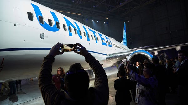 Employees take photos as United Airlines unveiled...