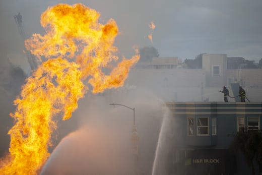 Firefighters battle a blaze following an explosion of a gas line on Feb. 6, 2019 in San Francisco, Calif.