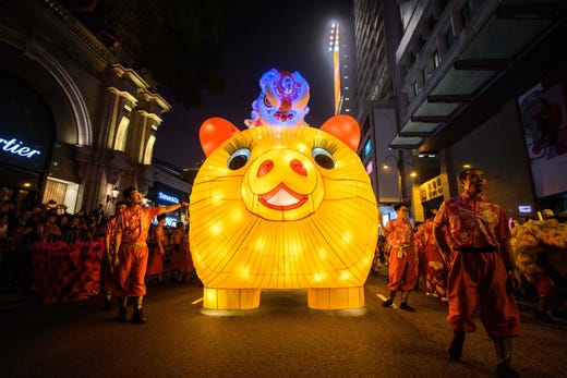 Performers walk with a lit model of a pig during the annual Lunar New Year parade in the Kowloon district of Hong Kong on Feb. 5, 2019, to mark the Year of the Pig.