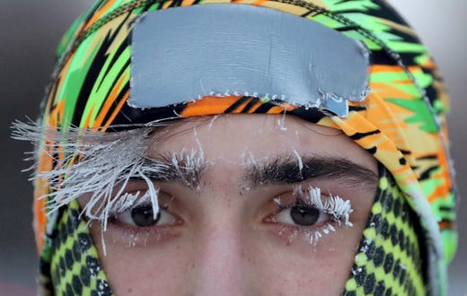 Frost covers part of the face of University of Minnesota student Daniel Dylla during a morning jog along Mississippi River Parkway Tuesday, Jan. 29, 2019, In Minneapolis. Extreme cold and record-breaking temperatures are crawling into parts of the Midwest after a powerful snowstorm pounded the region, and forecasters warn that the frigid weather could be life-threatening. (David Joles/Star Tribune via AP) ORG XMIT: MNMIT101
