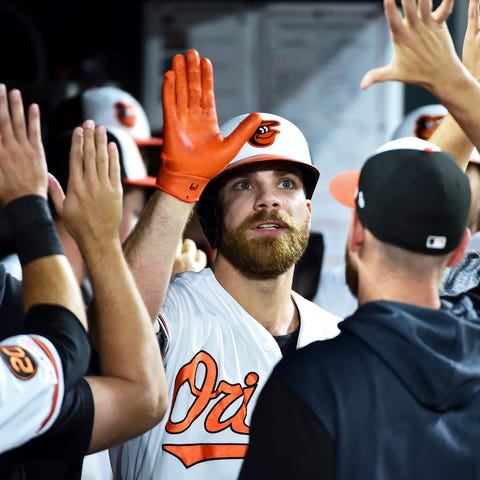 Chris Davis is congratulated after hitting a home...