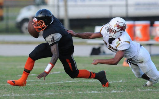 Astronaut's J.T. Hassell (1) sacks Cocoa QB Bruce Judson (4) during a game at Cocoa Stadium.