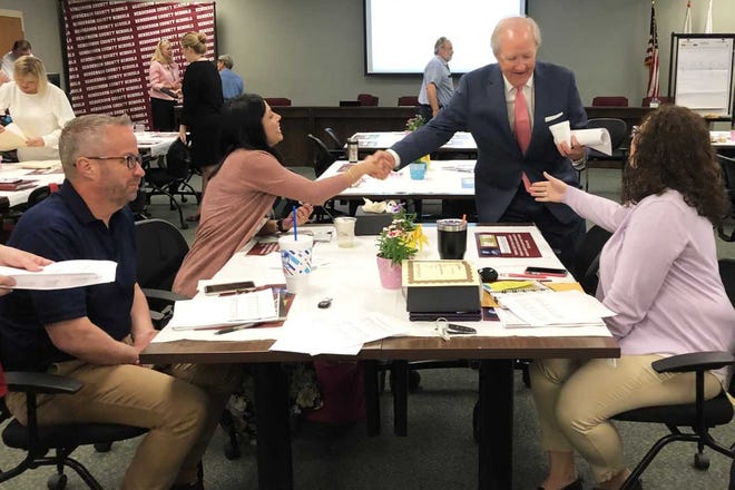Joel Hopper (center) shakes hands Tuesday to congratulate Spottsville Elementary School Principal Sarah Estabrook (at left) and Jefferson Elementary Principal Crissy Sandefur. The two principals recently graduated from the Kentucky Chamber Foundation’s Leadership Institute for School Principals, of which Hopper is co-chair.