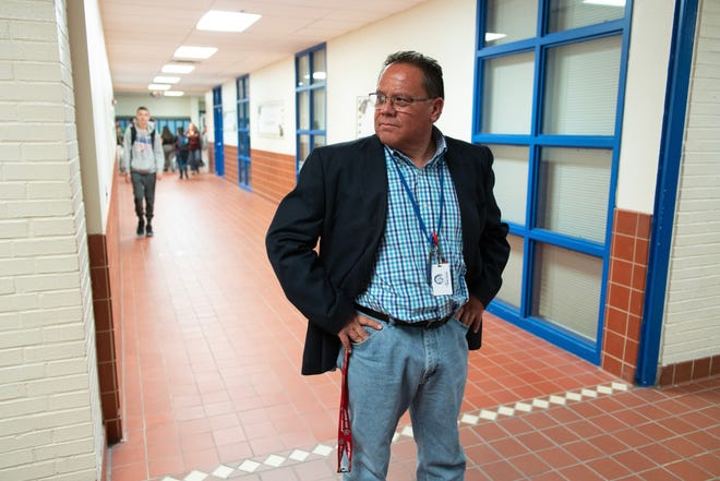 Principal Mario Zuniga stands in the hallway of Socorro High School during a break between classes.