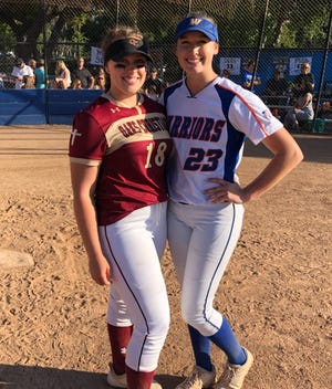 Oaks Christian’s Taylor Johnson and Westlake’s Alexa Campbell, who began playing softball together in Thousand Oaks at age 7, pose after Westlake’s Senior Day on Wednesday.
