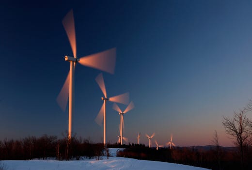 Wind turbines are bathed in the first rays of sunlight at the Saddleback Ridge Wind Project, March 20, 2019, in Carthage, Maine. 