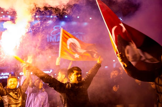 Supporters of the main opposition Republican People's Party wave flags and light up torches to celebrate the local election in Istanbul, Turkey on April 1, 2019.