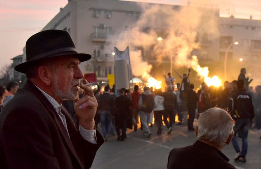 People light torches during a protest against President Milo Djukanovic in Montenegro's capital Podgorica, March 23, 2019, demanding the resignation of long-serving President Milo Djukanovic. 