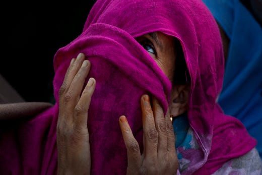 A Kashmiri Muslim woman prays as the head priest displays a relic at the Hazratbal shrine on the occasion of Mehraj-u-Alam, believed to mark the ascension of Prophet Muhammad to heaven, in Srinagar, Indian-controlled Kashmir, on April 4, 2019. Thousands of Kashmiri Muslims gathered at the Hazratbal shrine, which houses a relic believed to be a hair from the beard of Islam's Prophet Muhammad.