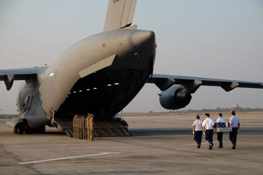 US military honor guards carry the flag draped coffin bearing the recovered remains of suspected American airmen during a repatriation ceremony at the Mandalay International Airport on March 12, 2019. The remains of suspected American airmen killed in Myanmar during World War II were repatriated to the United States on March 12 in the first-ever ceremony of its kind in the Southeast Asian nation, US officials said.