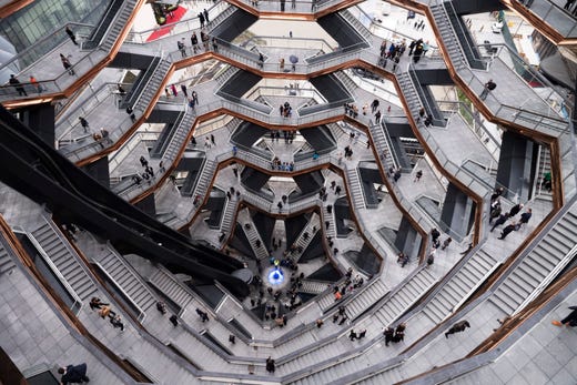 Visitors to the "Vessel" climb its staircases on its opening day at Hudson Yards, March 15, 2019, in New York. Hudson Yards, a $25 billion urban complex on Manhattan's west side, is the city's most ambitious development since the rebuilding of the World Trade Center. When fully complete, the 28-acre site will include 16 towers of homes and offices, a hotel, a school, the highest outdoor observation deck in the Western Hemisphere, a performing arts center, Vessel and a shopping mall. 