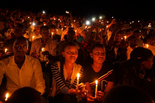 Rwandans sitting in the stands hold candles as part of a candlelit vigil during the memorial service held at Amahoro stadium in the capital Kigali, Rwanda, April 7, 2019. Rwanda is commemorating the 25th anniversary of when the country descended into an orgy of violence in which some 800,000 Tutsis and moderate Hutus were massacred by the majority Hutu population over a 100-day period in what was the worst genocide in recent history.