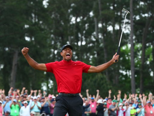 Tiger Woods celebrates after making a putt on the 18th green to win The Masters golf tournament at Augusta National Golf Club in Augusta, Ga. on April 14. 2019.