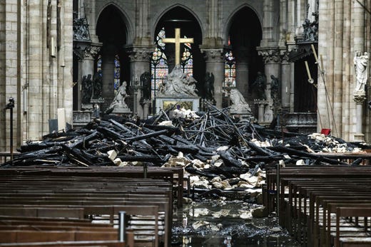 The altar surrounded by charred debris inside the Notre-Dame Cathedral in Paris on April 16, 2019 in the aftermath of a fire that devastated the cathedral.