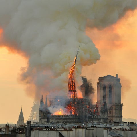 Flames and smoke rise from the blaze as the spire 