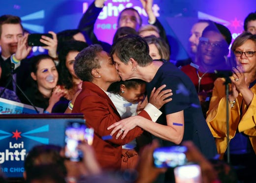 Chicago mayor elect Lori Lightfoot (L) kisses wife Amy Eshleman after speaking during the election night party in Chicago on April 2, 2019. In a historic first, a gay African American woman was elected mayor of America's third largest city as Chicago voters entrusted a political novice with tackling difficult problems of economic inequality and gun violence.