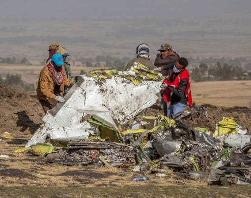 Rescuers work at the scene of an Ethiopian Airlines flight crash near Bishoftu, south of Addis Ababa, Ethiopia, March 11, 2019. A spokesman says Ethiopian Airlines has grounded all its Boeing 737 Max 8 aircraft as a safety precaution, following the crash of one of its planes on March 10 in which 157 people were killed.