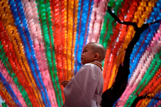 A child stands after having his head shaved during a ceremony entitled 'Children Becoming Buddhist Monks', at the Jogye temple in Seoul on April 22, 2019. Following the ceremony the children stay at the temple where they are taught about Buddhism, for two weeks, until Buddha's birthday on May 12. 