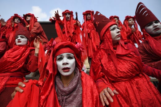 The Blood of the Extinction theatrical group perform during Extinction Rebellion climate change protests on Waterloo Bridge, during climate change protests in London on April 17, 2019.
