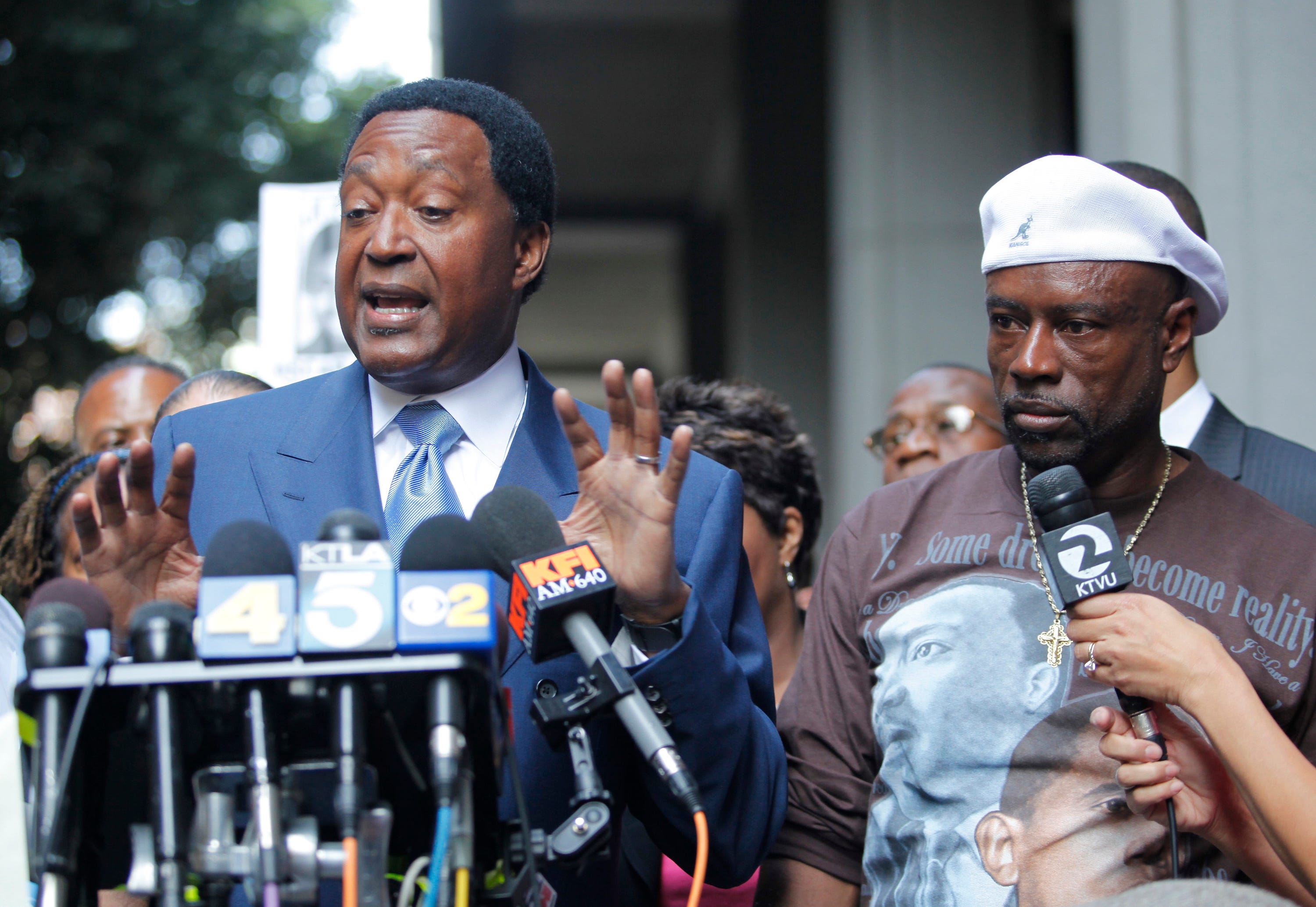 In this 2010 photo, John Burris, left, the Oscar Grant family attorney, and Cephus "Uncle Bobby" Johnson, right, express their disappointment outside a Los Angeles court after a jury found BART police officer Johannes Mehserle only guilty of involuntary manslaughter of Grant while he laid on his stomach on an Oakland train platform.