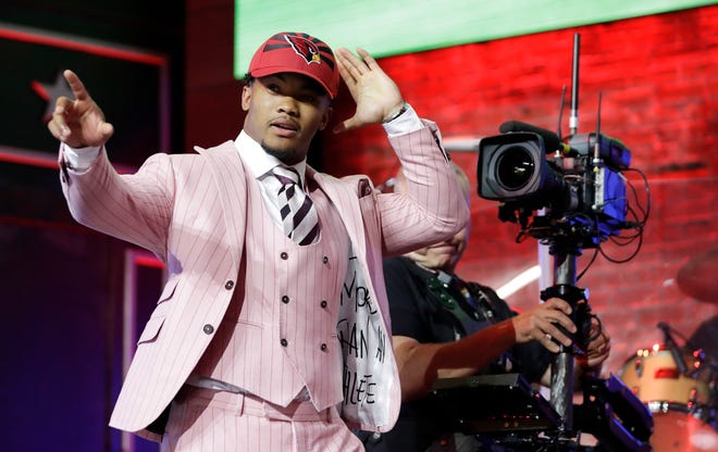 Oklahoma quarterback Kyler Murray waves after the Cardinals selected him with the No. 1 overall pick.
