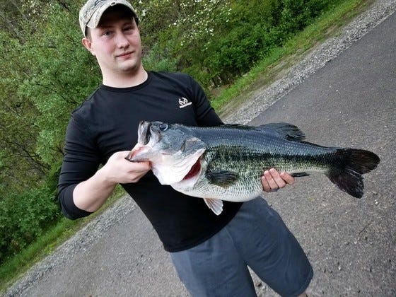Mark Ward poses with this 14-pound, 9.5 ounce record largemouth bass.