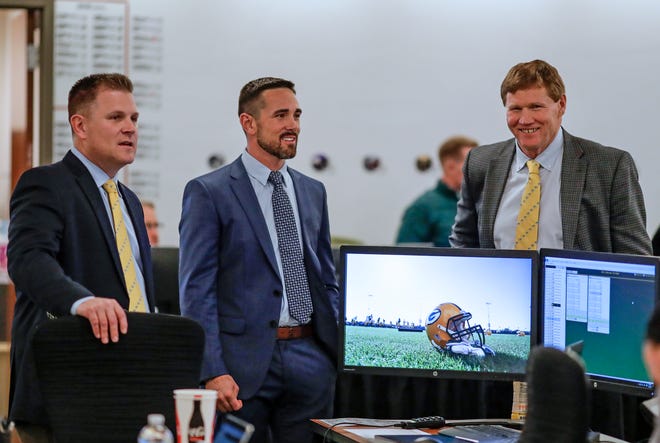 Green Bay Packers general manager Brian Gutekunst, from left, coach Matt LaFleur and president Mark Murphy chat in the team's draft room Thursday, April 25, 2019, at Lambeau Field in Green Bay.