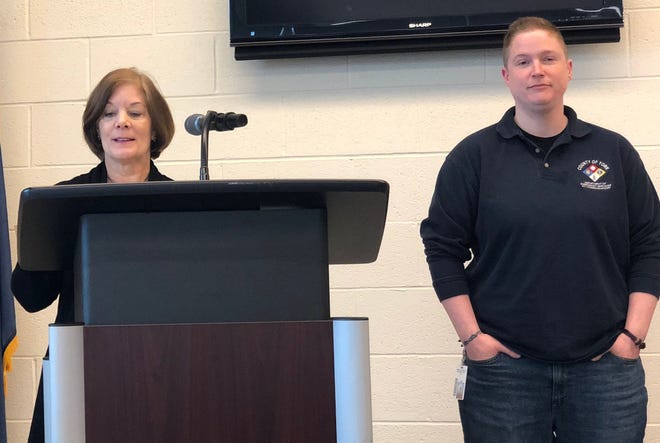 York County 911 dispatcher Katie Flynn (at right) was named the county's telecommunicator of the year at a ceremony on April 18, 2019. At left, York County Commissioner Susan Byrnes talks about Flynn's accomplishments.