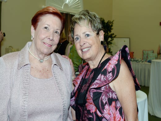 Hibiscus Guild members Helen Robertson, left, and Roni Fuster at the 20th Anniversary Blue Ribbon Luncheon & Fashion Show at Oak H   arbor Club in Vero Beach.