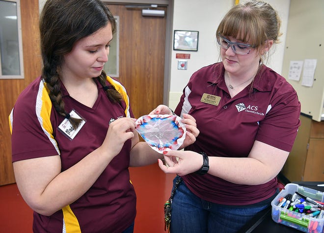 Maddison Addison, left, and Raelene Keesling of Midwestern State University's chemistry department demonstrate a chromotography experiment that would be used during the Chemistry Carnival for Boys and Girls Club members.