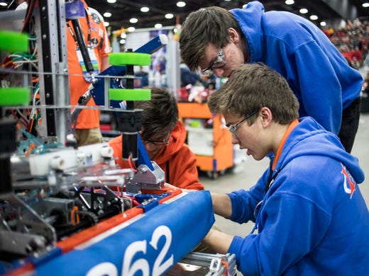From left, Team 862 Lightning Robotics from Canton, Aiden Milwski, Luke Fenstermacher, and Nick Lipcsik adjust their robot before the FIRST Robotics World Championship semifinal at Cobo Center in Detroit, Saturday, April 27, 2019.