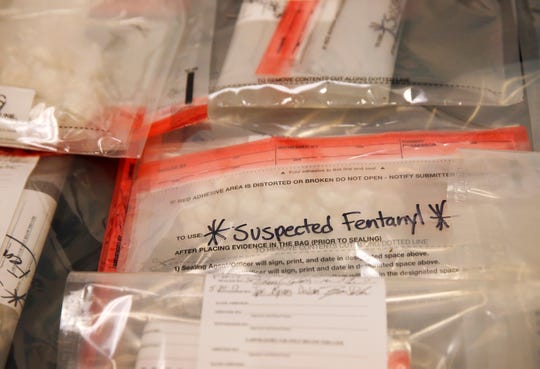 Suspected fentanyl is seen on a table as officials gather at a press conference to announce federal drug, firearm and immigration charges against 30 defendants from the city of Lawrence, Mass., and surrounding communities at Moakley Federal Courthouse Tuesday, May 30, 2017, in Boston. The U.S. Attorney's office said Tuesday the 30 indictments are part of a yearlong investigation dubbed "Operation Bad Company" that targeted the fentanyl, heroin and cocaine trafficking ring in the state.  (Jessica Rinaldi /The Boston Globe via AP)