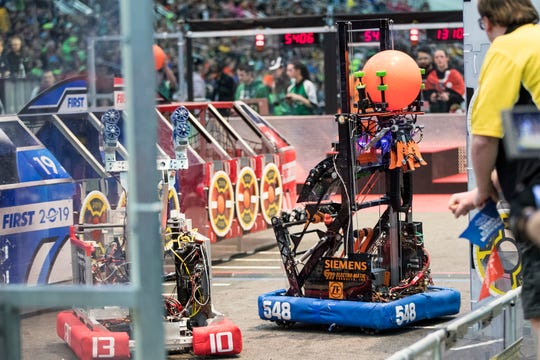Robots from Team 548 Robostangs of Northville, and 1310 from Runnymede Robotics of Toronto compete during the FIRST Robotics World Championship semifinal at Cobo Center in Detroit, Saturday, April 27, 2019.