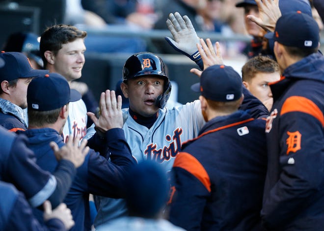 Detroit Tigers first baseman Miguel Cabrera is congratulated by teammates in the dugout following a solo home run against the Chicago White Sox during the first inning of Detroit's loss Friday night.