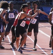 Ryan Fernando hands the baton to Gabe Pineda of Paramus as they competed in the 4x400 relay.