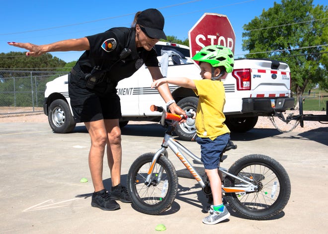 Alec Davis, 4, learns the rules of the road  from Mary Ann Teries, a code enforcement officer with the Las Cruces Police Department, during the 10th annual Family Bike Fiesta Saturday, April 27, 2019, at Lynn Middle School.