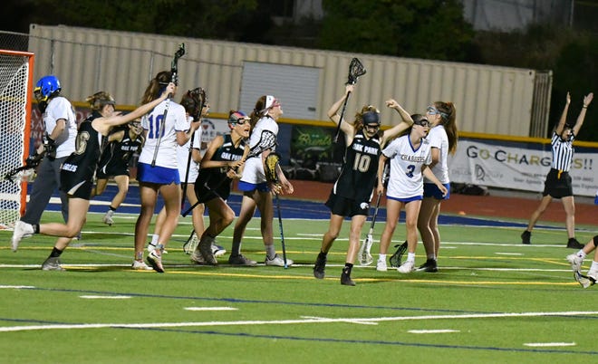 Oak Park senior Erin Dotson, center, celebrates scoring the winning goal with three seconds in overtime of the inaugural Coastal Canyon League girls lacrosse championship tournament.