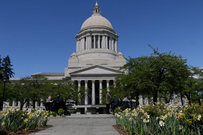 People wait at the sundial outside of the Washington Capitol on Saturday, APril 27, 2019, in Olympia, Washington.