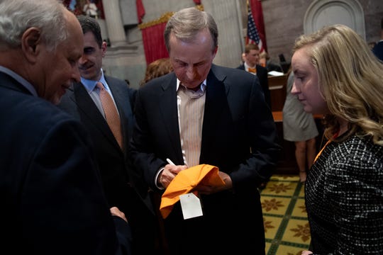 Tennessee men's college basketball coach Rick Barnes signs autographs after being honored during a joint convention at the state Capitol building in Nashville, Tenn., Monday, April 29, 2019.