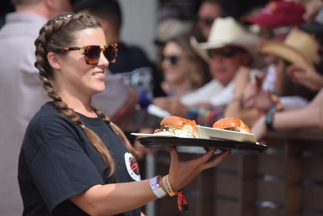Serving up pulled pork in Guy Fieri’s booth during the Stagecoach country music festival in Indio, Calif. on April 28, 2019.