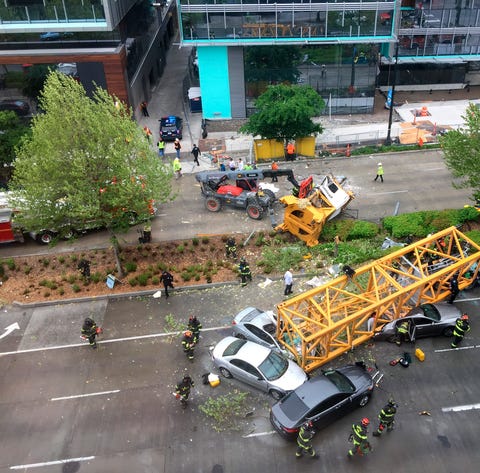 Fire and police crew members work to clear the sce
