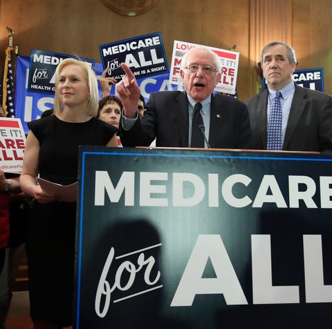 Sen. Bernie Sanders, flanked by Sens.. Kirsten...