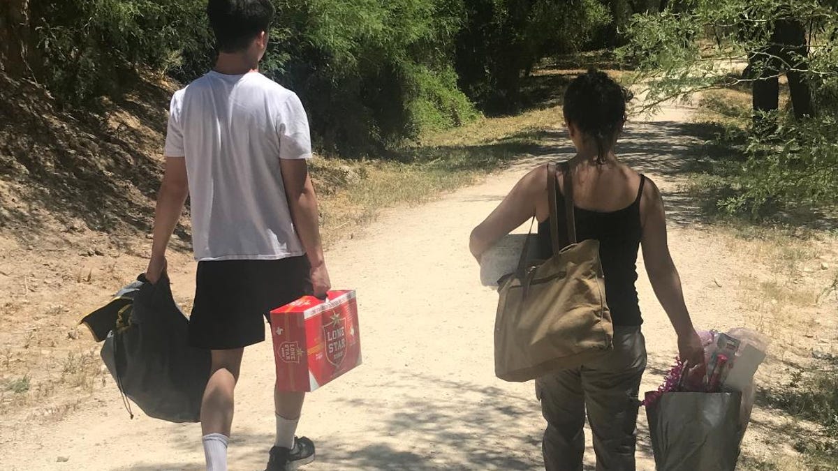 Thuan Le Elston and her son Kien-Tam help carry Easter party donations on April 17, 2019, from Texas for the border village of Boquillas, Mexico.