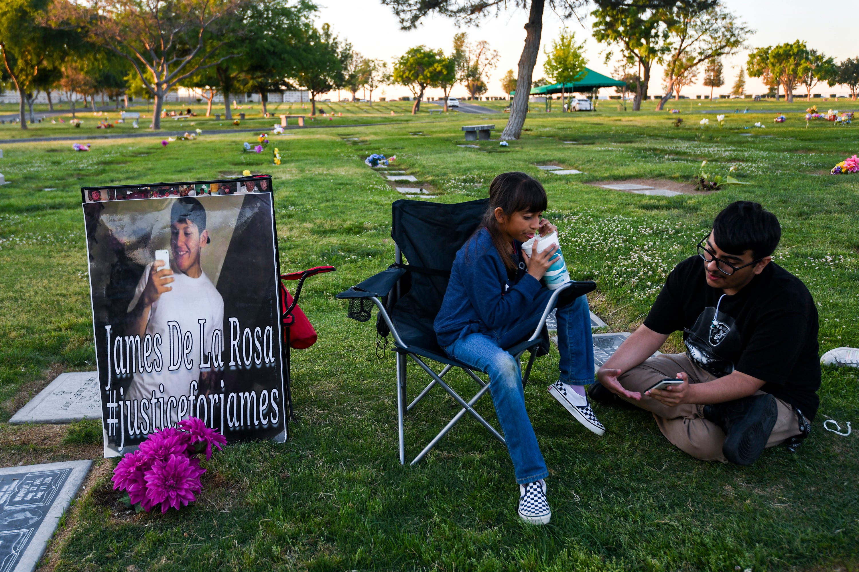 Leticia de la Rosa and her family spend the evening at Greenlawn Cemetery to celebrate the birthday of James de la Rosa.
