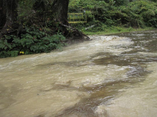 The North Toe River below LIttle Bear Creek in Spruce Pine takes on a brown, milky color due to turbidity and other pollutants after a rainstorm. The state DEQ is holding a public hearing on wastewater discharge permits for mining companies along the river.