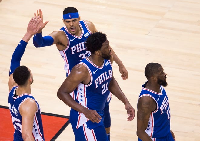 Philadelphia forward Tobias Harris, a former Piston, high-fives guard Ben Simmons as teammates Joel Embiid (21) and James Ennis III (11) look on after the win over Toronto.