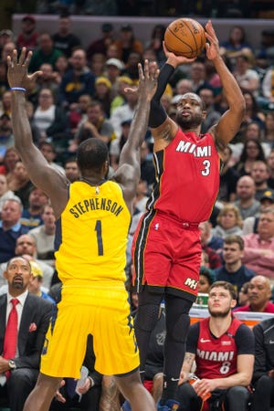 Mar 25, 2018; Indianapolis, IN, USA;  Miami Heat guard Dwyane Wade (3) shoots the ball over Indiana Pacers guard Lance Stephenson (1) in the first half against the Miami Heat at Bankers Life Fieldhouse. Mandatory Credit: Trevor Ruszkowski-USA TODAY Sports